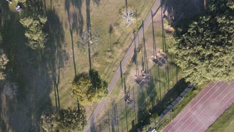 aerial top down view of kids enjoying swings in outdoor park during evening