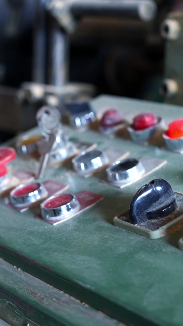 Dusty Vintage Machine Control Panel with Red Buttons and Key