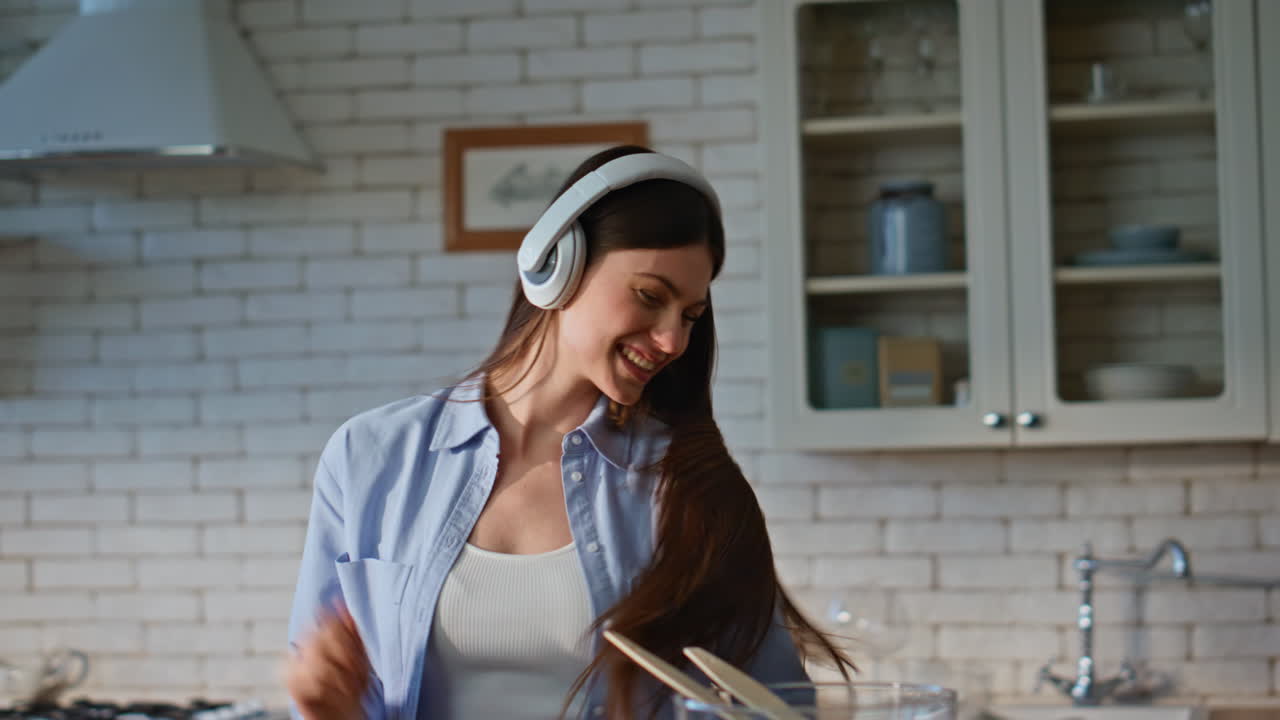 Housewife hands mixing salad in kitchen closeup. Joyful girl dancing cooking