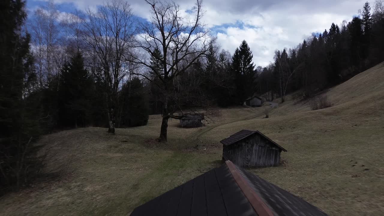Drone fly over Wooden Huts in Austrian Mountains with Snow Covered Summits in Background.Nenzing, Europe