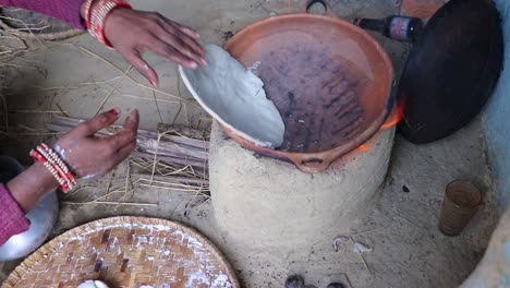 rice floor bread making in traditional soil vessels at wood fire from different angle