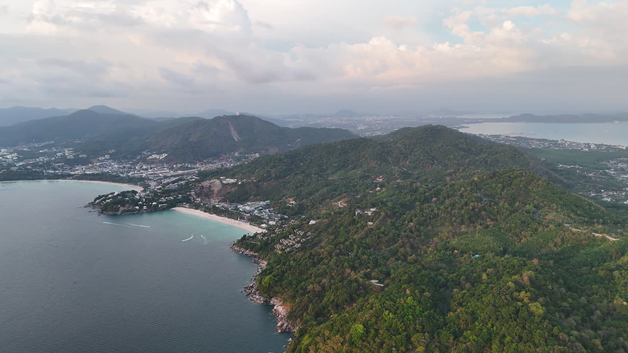 Coastal Towns Of Karon And Rawai With Lush Green Hills And Foggy Landscape In Background. Phuket, Thailand. aerial panning shot