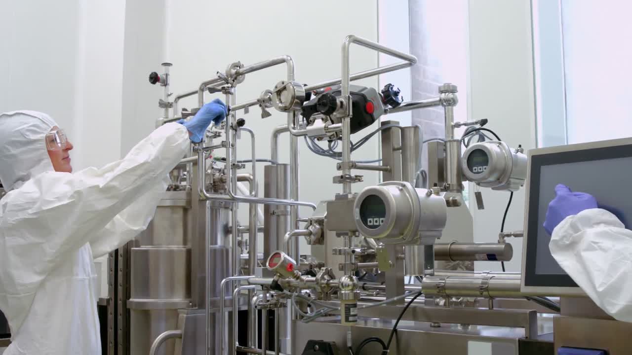 Scientists in protective suits working together
