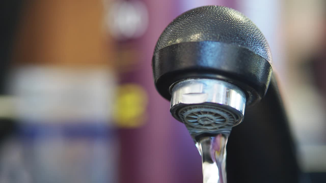 Close-up of Water Dripping from a Kitchen Faucet