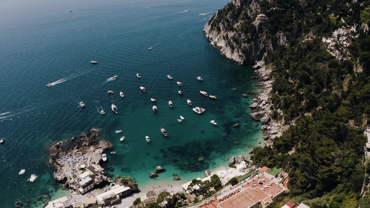 Wide aerial view of boats lining Italy's coastal water
