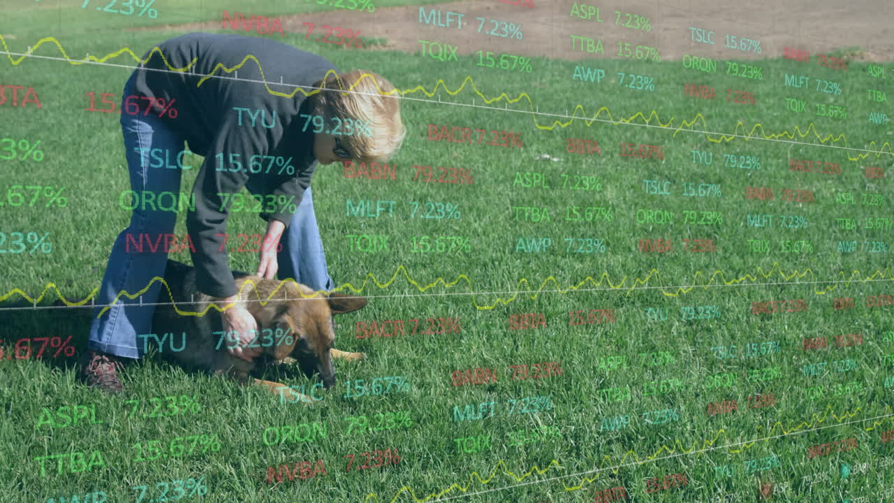Person playing with dog on grass, stock market data overlay animation