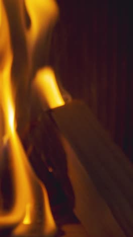 Vertical-Video-Close-Up-Flames-Fire-Logs-In-Wood-Burning-Stove-At-Home