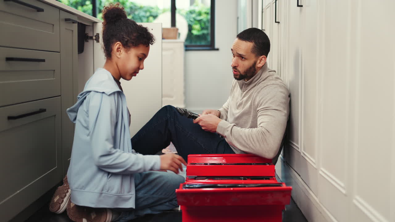 Father and Daughter Working on Repairs Together
