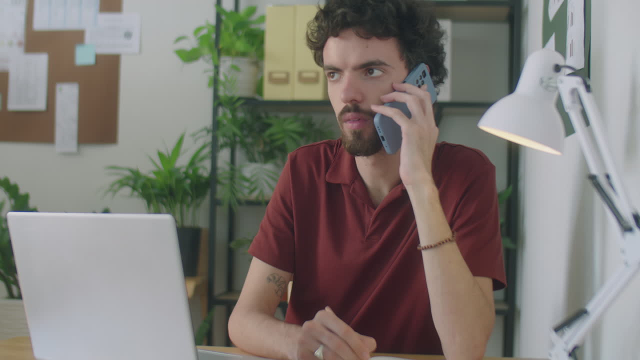 Office Manager Speaking on Phone and Taking Notes