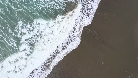 4k-birds-eye-view-of-waves-crashing-on-sandy-beach-in-brookings-oregon