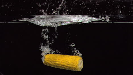 corn cob falling into water in super slow motion