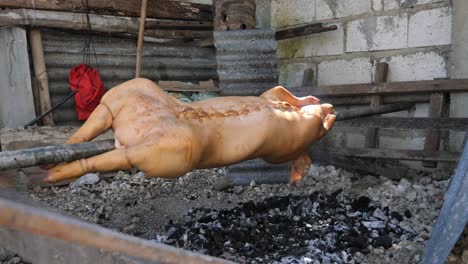 April-22,-2023-Danao-City,-Cebu,-Philippines---A-Lechon-Baboy-or-Suckling-Pig-is-beeing-Roasted-over-Charcoal-Fire