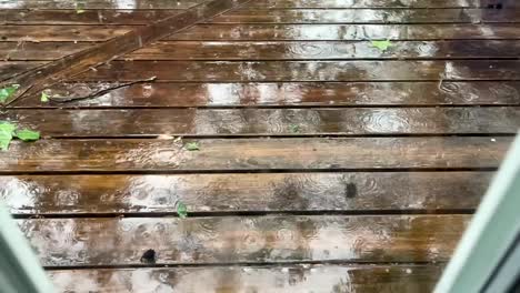 rain storm outside window viewing wood deck still shot