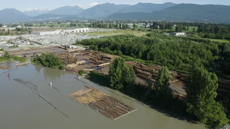 drone shot of a river-bank lumber processing plant