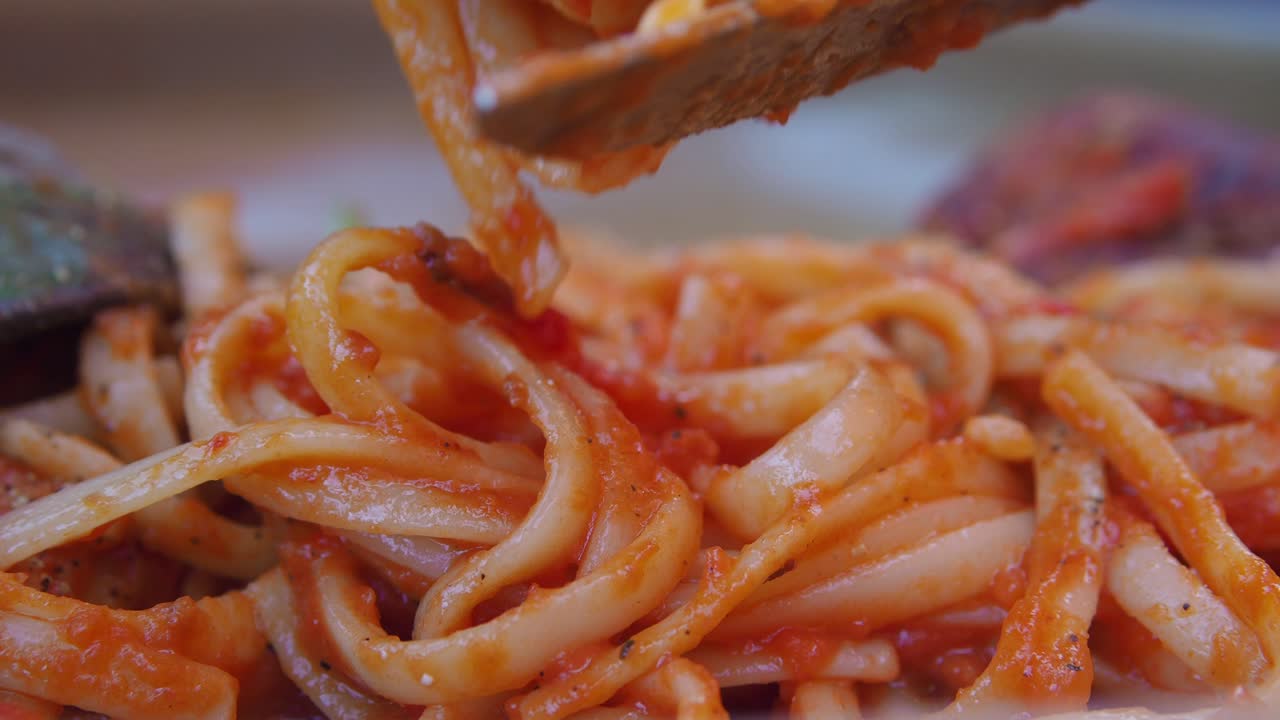 Close-up of Delicious Pasta with Tomato Sauce Being Served