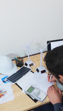 creative engineer drawing a diagram for a sustainable solution