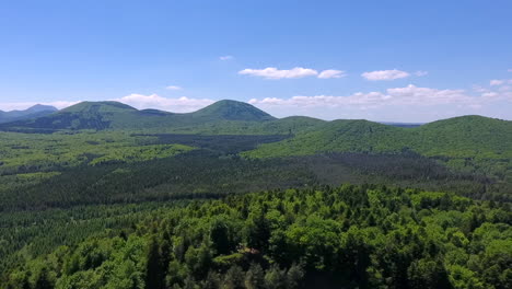 drone pull back and reveal shot of volvic volcano and forest in france