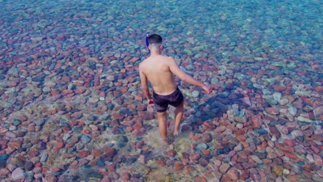 a guy getting heading to the sea for snorkeling