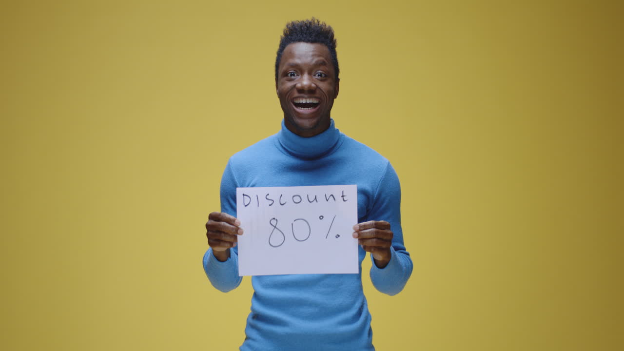 Man showing 80% discount sign