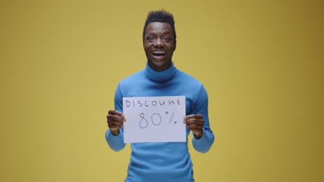 man showing 80% discount sign