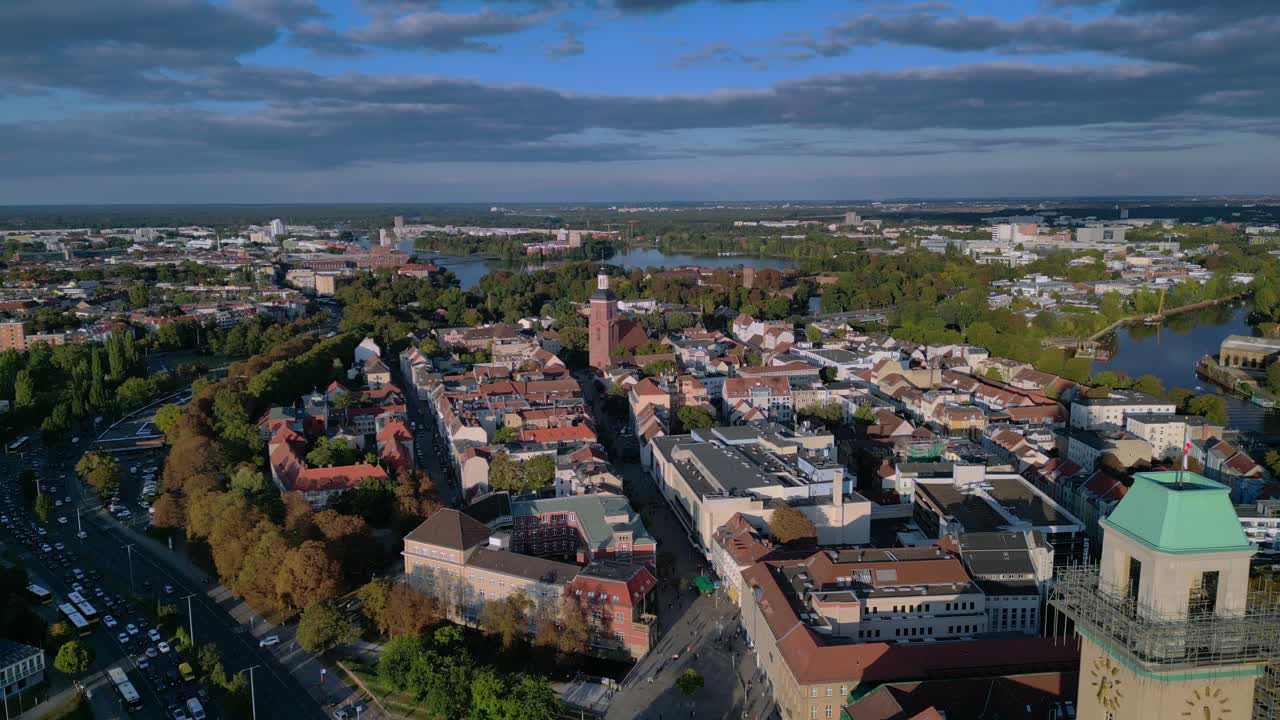 Berlin Spandau old town with its red rooftops, churches, and surrounding greenery. Smooth aerial view flight drone shot from above