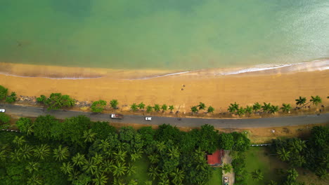 top down drone shot of traffic at the praia emilia beach in ana chaves bay, sao tome