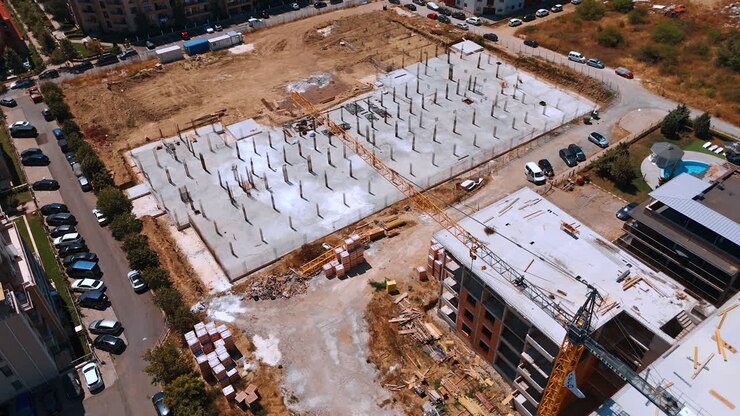 Varna, Bulgaria, 11 July 2025: Urban construction site. Workers are developing a large construction site with a foundation laid in an urban area during daylight hours