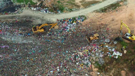 birds eye view, flyover a sprawling landfill with vast, unsorted waste piles, showcasing environmental sustainability concerns, microplastics and consequences of global warming and climate change