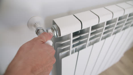 Beautiful-slow-motion-shot-of-a-young-man's-hand-turning-on-the-heating-in-his-room-by-moving-the-quantity-knob