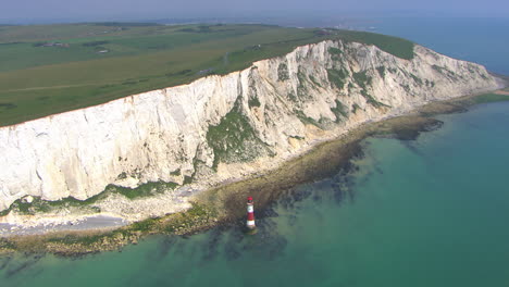 aerial rotating shot around a lighthouse off the coast of the white cliffs of dover