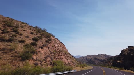 A-deserted-highway-winds-through-roughed-desert-terrain