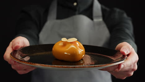 chef presenting a gourmet caramel dessert