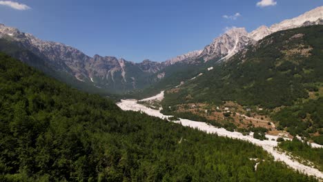 valley surrounded by green forest and alps mountains on summer in valbona, albania