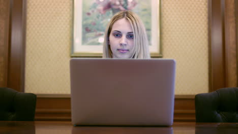 business woman opening notebook computer and looking on screen