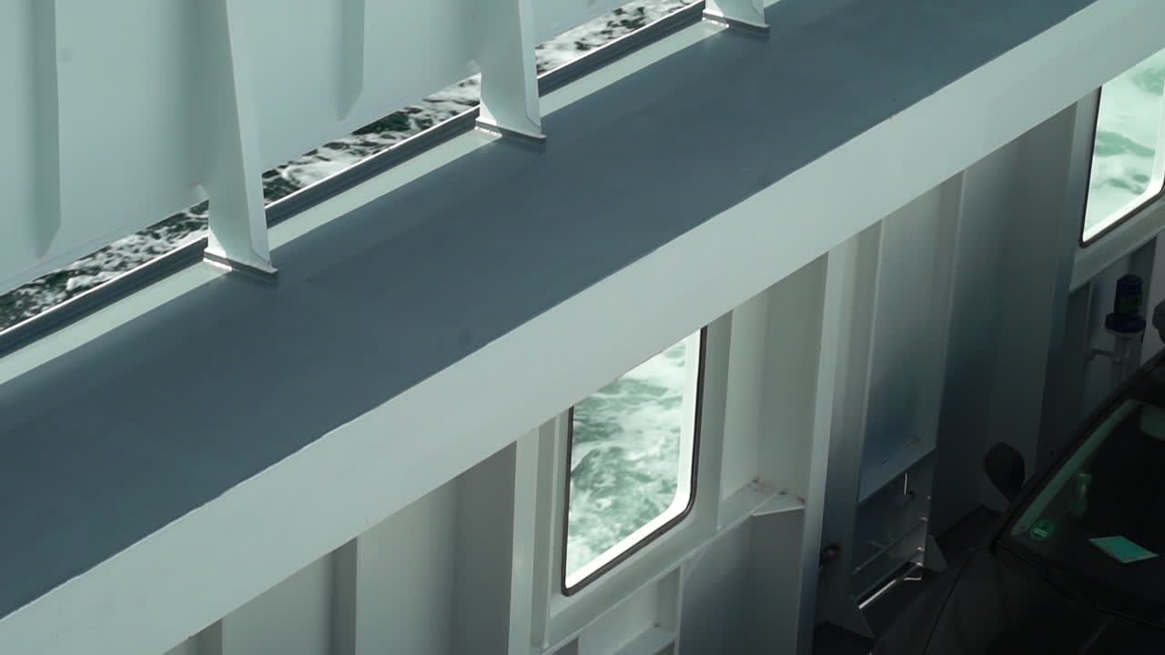 Abstract view of a ferry's white structure with glimpses of the sea