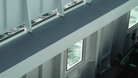 abstract view of a ferry's white structure with glimpses of the sea