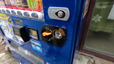 person buys a drink from a vending machine