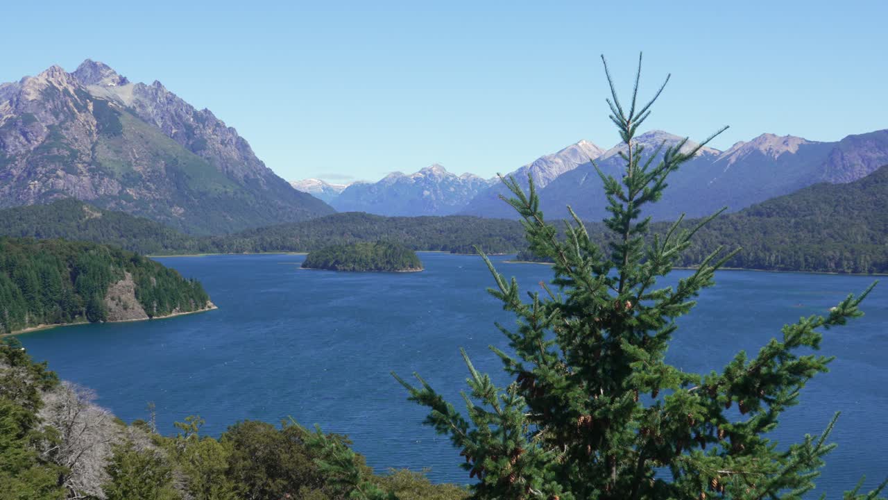 Static shot from a viewpoint on Circuito Chico overlooking Lake Perito Moreno with forests, islands, and the Andes mountain range. Nahuel Huapi National Park, Bariloche, Patagonia, Argentina