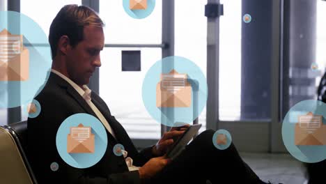 animation of message icons floating over caucasian businessman using digital tablet at an airport
