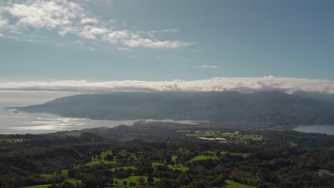 aerial pan right drone footage of tahiti island from mountain top to reveal the island and its stunning landscape