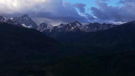 Capital-Peak-Old-Mount-Snowmass-Resort-Colorado-aerial-drone-pan-left-slowly-dark-clouds-sunset-Mt-Sopris-Sopras-Maroon-Bells-Aspen-Wilderness-summer-June-July-Rocky-Mountains-peaks-National-Forest