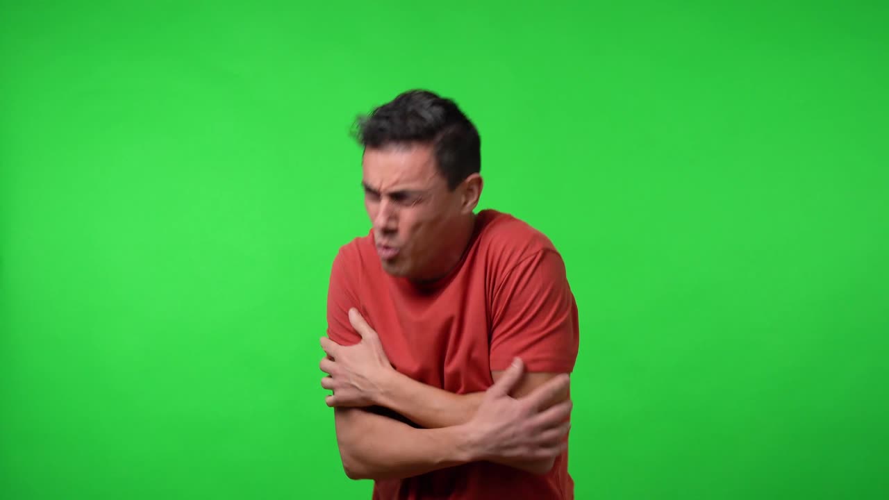Man who is very cold hugging himself