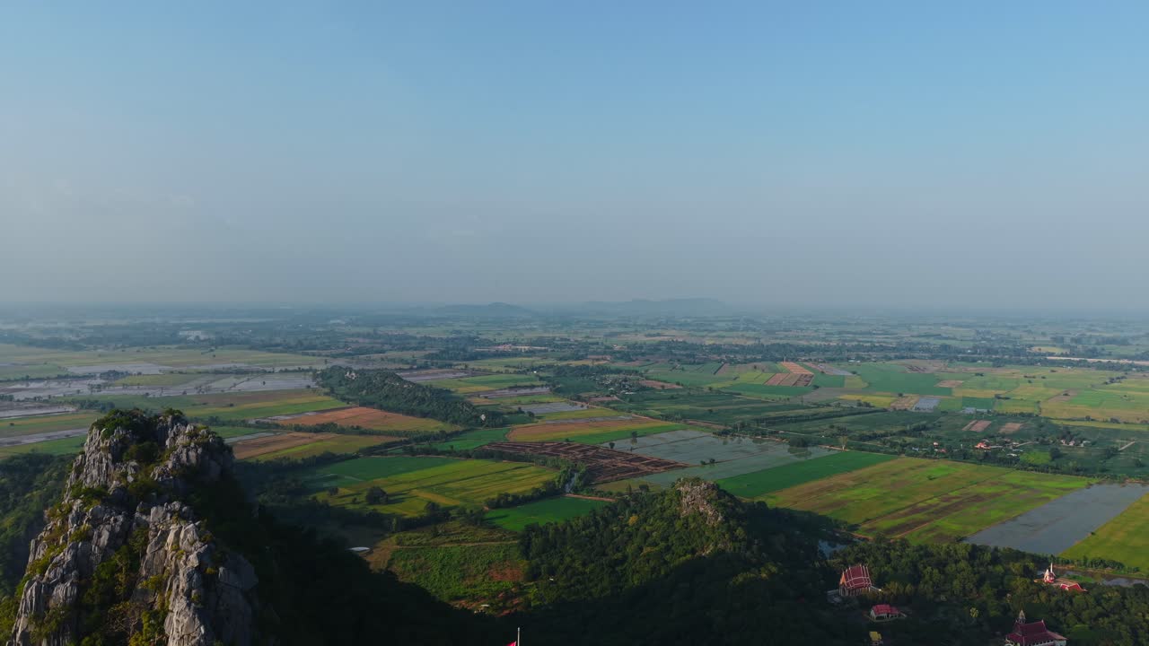 Aerial View of Thai Mountainous Landscape with Rice Paddies and Temple