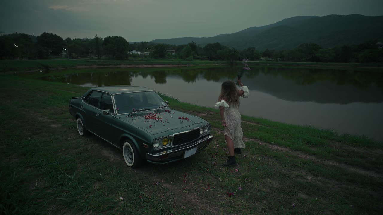 Woman by Vintage Car near a Lake at Dusk