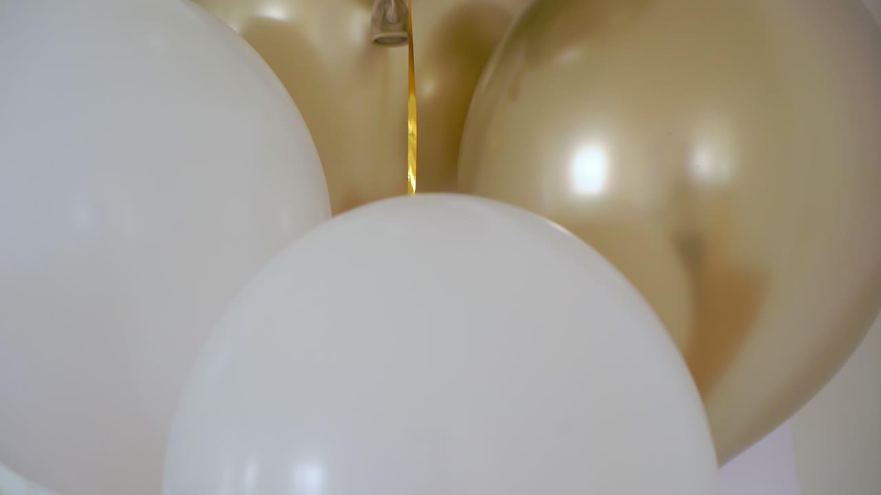 Yellow gold and white balloons. Holiday decoration indoors