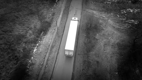 Aerial-shot-of-a-truck-on-the-road-in-the-winter