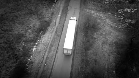 aerial shot of a truck on the road in the winter