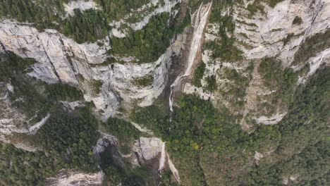 drone flight over the magnificent seerenbachfälle falls, showcasing the beauty of the swiss alps.