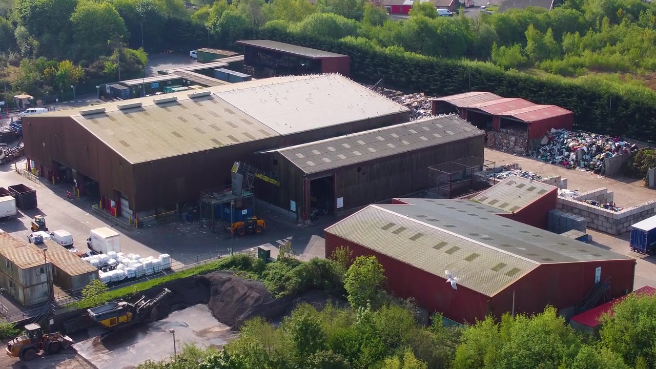 Aerial View of Modern Recycling Center and Green Sorting Facility. Sustainable waste management. Industrial-scale recycling. Environmental impact films, climate change documentaries, and news b-roll.