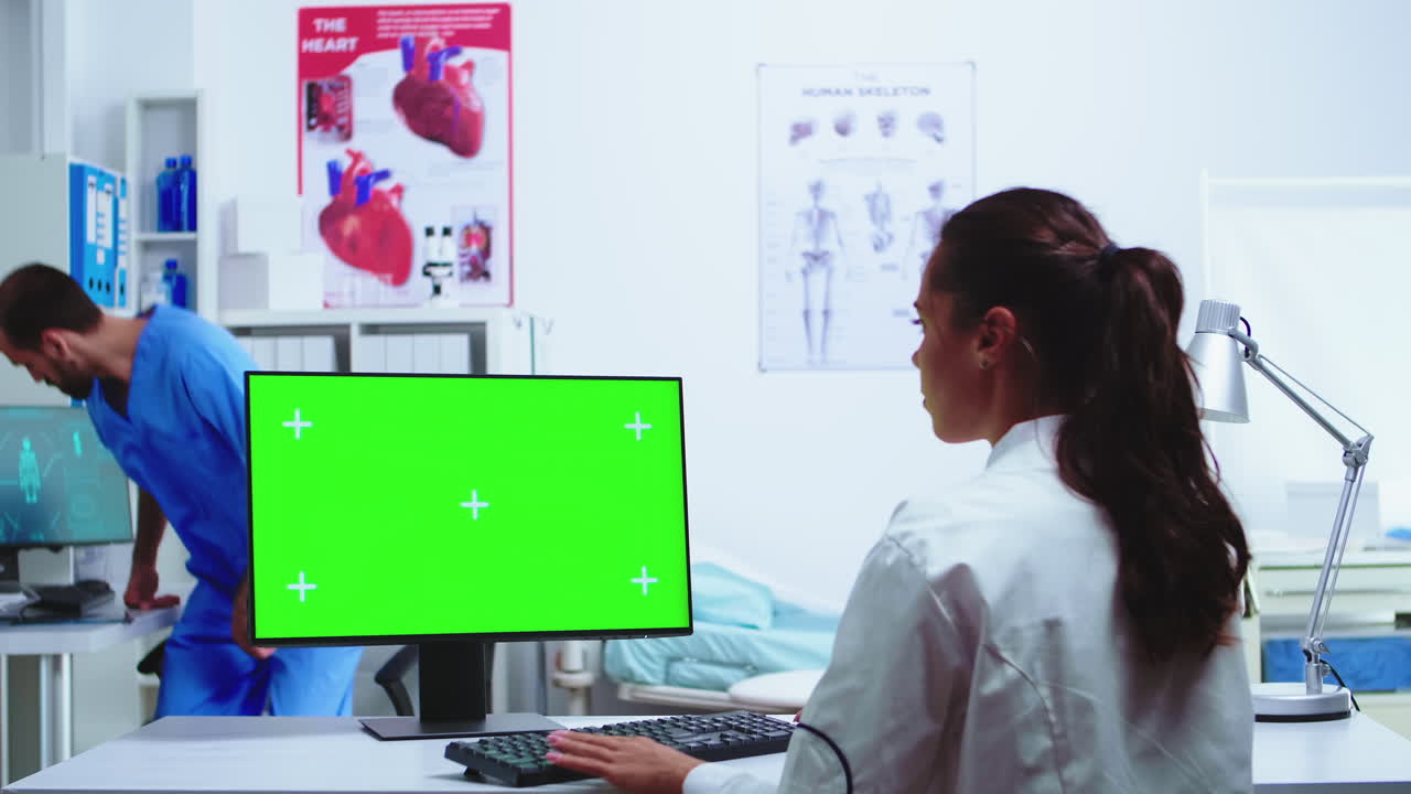 의사 는 컴퓨터 에서 메모 를 하고 있다